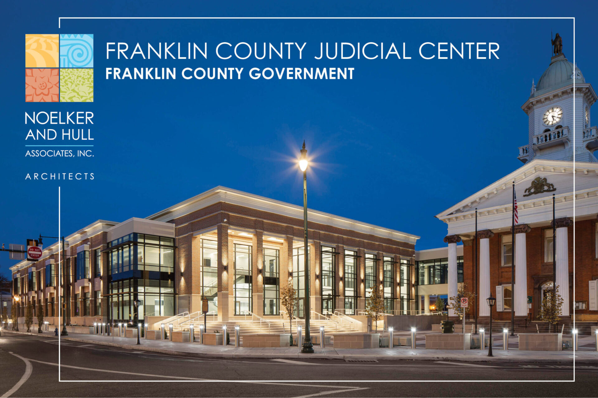 new judicial center and historic courthouse at night